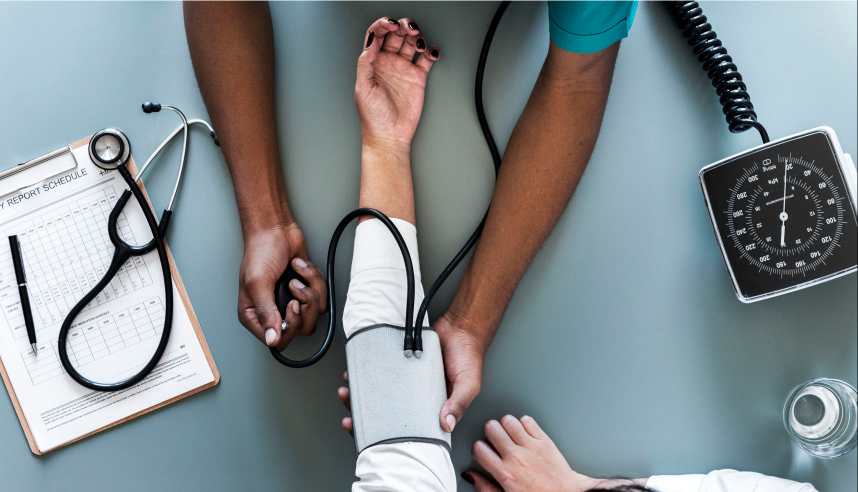 Stressed NHS doctor having blood pressure taken
